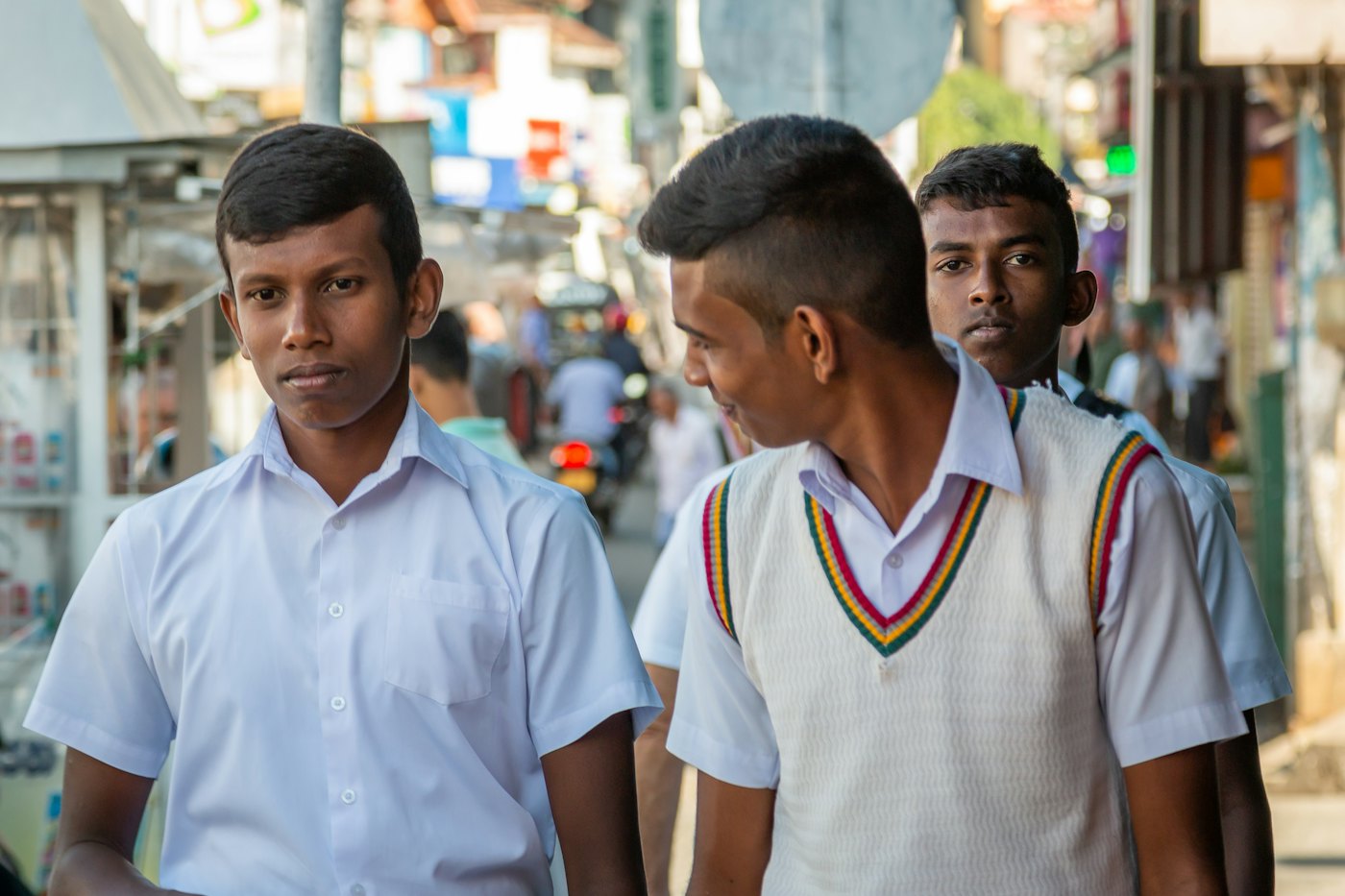 Sri Lankan schoolboys in white uniforms walking together