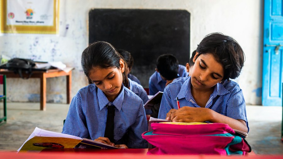 Two schoolgirls working on maths at their desks